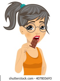 Cute girl with glasses eating chocolate