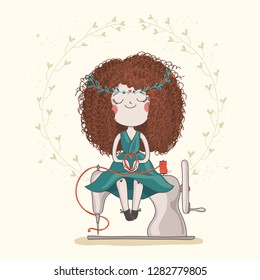 Cute girl in green dress with fluffy red haircut is sitting on the sewing machine and holding heart from thread. Hand made or DIY character