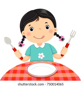 Cute girl holding a spoon and fork with empty white plate on white background