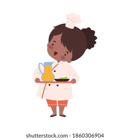 Cute Girl Holding Tray with Jug of Juice, Cute Little Chef Character in Uniform Cooking in the Kitchen Cartoon Style Vector Illustration