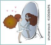 cute girl looking at her reflection in mirror.