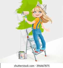 Cute girl in overalls and paper hat standing on a stepladder with a paint roller 