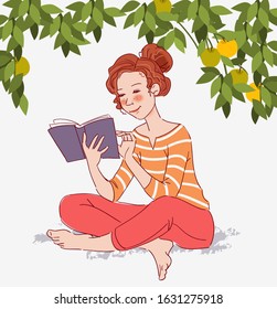 Cute girl reads a book in garden