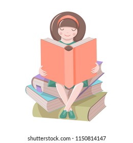 Cute girl is sitting on a pile of books and reading an interesting book. Isolated on white background.