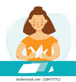 A cute girl is sitting at the table and making a crane out of paper. Woman makes origami. Vector flat illustration.