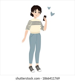 Cute girl in striped sweater holding a smartphone 