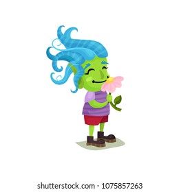 Cute girl troll with blue hair and green skin sniffing a pink flower, funny fairy tale character vector Illustrations on a white background