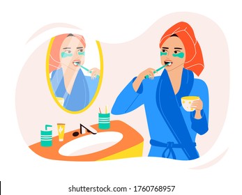 A cute girl in a turban and a dressing gown stands at the mirror and brushes her teeth, holds a mug in her hands. Daily morning routine, care for teeth and beauty. Colorful vector flat illustration.