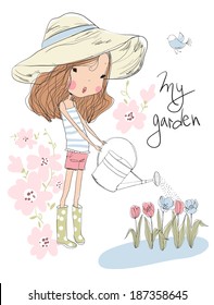 Cute girl watering flowers in the garden 