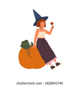 Cute girl wearing witch hat hold lollipop and sit on Halloween pumpkin. Portrait of young sorcerer with red hair. Flat vector cartoon childish illustration of mage isolated on white background