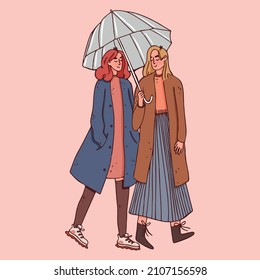 Cute girls LGBT couple going for a walk under an umbrella