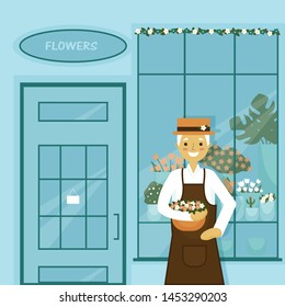 Cute grandfather stands at the window of a flower shop. He has beautiful beautiful flowers that he wants to give to people and make them happy.