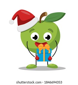 Cute green apple in a red Christmas hat with a gift box. Little fruit character. Vector flat illustration.