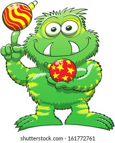 Cute green monster with sharp fangs and yellow stripes while smiling, posing and holding and balancing beautiful Christmas balls