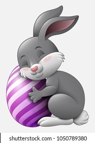 Cute grey Easter Bunny hugged egg decorated isolated on a white background