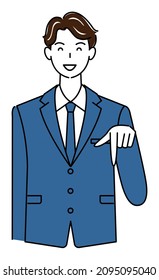 A cute guy in a suit smiling and pointing his finger in the direction below. Business person illustration vector