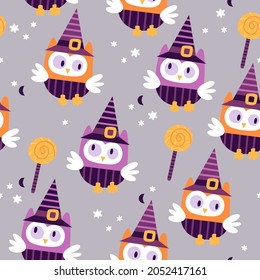 Cute Halloween owls in a witch hat with candy can, moon and groovy stars seamless pattern. Holiday kids design for clothes, paper, cover, fabrics and Halloween party celebration