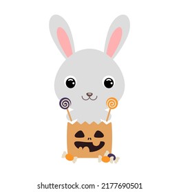 Cute Halloween rabbit sitting in a trick or treat bag with candies. Cartoon animal character for kids t-shirts, nursery decoration, baby shower, greeting card, invitation. Vector stock illustration