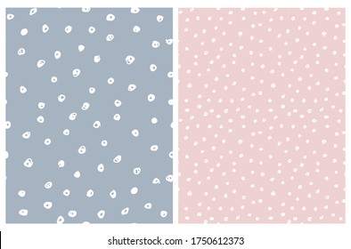 Cute Hand Drawn Abstract Irregular Polka Dots Vector Pattern Set. White Brush Dots on a Pale Blue and Light Pink Background. Bright Infantile Style Vector Print. Simple Dotted Layout.