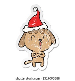 cute hand drawn distressed sticker cartoon of a dog wearing santa hat