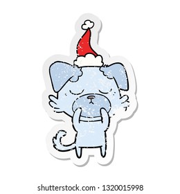 cute hand drawn distressed sticker cartoon of a dog wearing santa hat