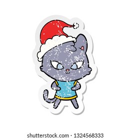 cute hand drawn distressed sticker cartoon of a cat wearing santa hat