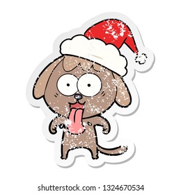 cute hand drawn distressed sticker cartoon of a dog wearing santa hat