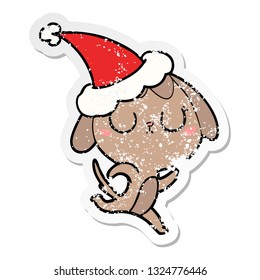 cute hand drawn distressed sticker cartoon of a dog wearing santa hat