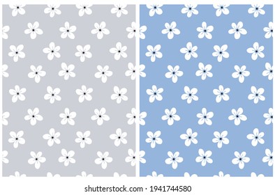 Cute Hand Drawn Irregular Floral Vector Patterns with White Tiny Flowers Isolated on a Blue and Light Gray Background. Funny Infantile Style Garden Print ideal for Fabric, Textile.