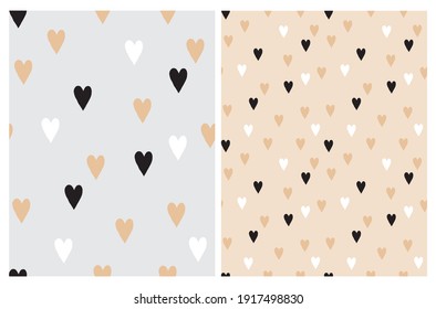 Cute Hand Drawn Irregular Hearts Vector Patterns. White, Black and Beige Hearts on a Light Gray and BeigeBackground. Funny Romantic Infantile Style Print. Love Symbol.