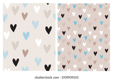 Cute Hand Drawn Irregular Romantic Vector Patterns with White, Black, Blue and Brown Hearts Isolated on a Light Brown and Beige Background. Funny Infantile Style Hearts Print.