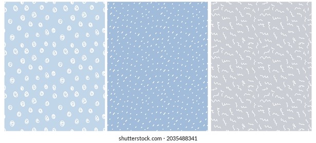 Cute Hand Drawn Irregular Vector Patterns with Tiny Polka Dots, scribbles and Spots Isolated on a Light Blue and Light Gray Background. Funny Infantile Style Geometric Design. Dotted Print.