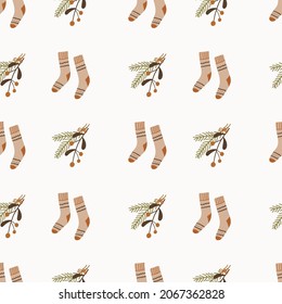 Cute hand drawn seamless pattern with fir tree branches and socks Cozy winter pattern. Vector illustration.