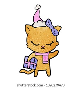 cute hand drawn textured cartoon of a cat with present wearing santa hat