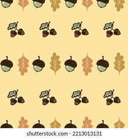 Cute hand-drawn acorns and oak leaves seamless pattern, a fall season yellow background