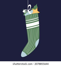 Cute hanging green christmas stocking full of small gifts. Vector illustration of funny decoration. Winter holiday greeting card design. Merry Christmas and Happy New Year.