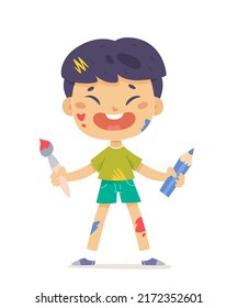 Cute happy boy artist holding paint brush and pencil to draw and create art pictures vector illustration. Cartoon isolated kid painter with dirty clothes and messy color splatters on face and body