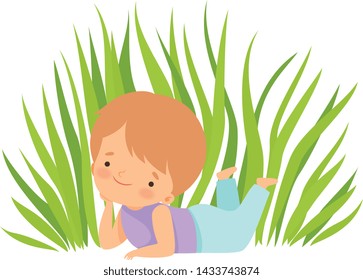 Cute Happy Boy Lying on Green Meadow, Adorable Little Kid Cartoon Character Playing Outside Vector Illustration