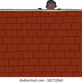 Cute Hispanic boy looking over brick wall