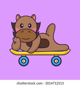 Cute horse lying on a skateboard.