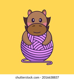 Cute horse playing with wool yarn.