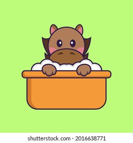 Cute horse taking a bath in the bathtub.