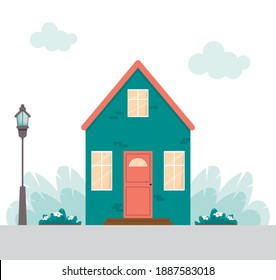 Cute House in flachem Stil. Hausfassade mit Tür und Fenster. Haus im Cartoon-Stil mit Straßenlaterne und Blumenbeeten. Illustration auf weißem, isoliertem Hintergrund.
