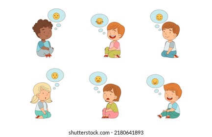 Cute kids expressing emotions set. Little girls and boys sitting on floor with emoticons in speech bubbles cartoon vector illustration