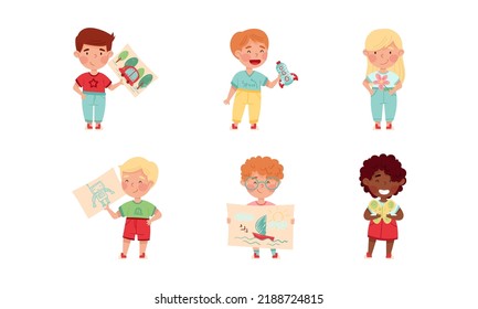 Cute kids showing their DIY crafts set. Boys and girl holding drawings cartoon vector illustration