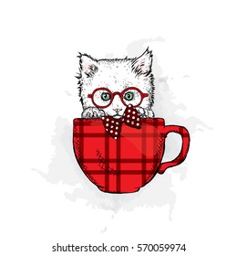 Cute kitten in a cup. Vector illustration.