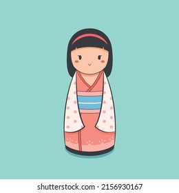 Cute kokeshi doll on a light background with pink kimono