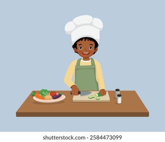 Cute little African boy chef cooking meal cutting slicing cucumber vegetable with knife in the kitchen