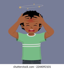 cute little African boy feeling dizzy having a headache with hand touching his head