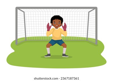 Cute little African boy goalkeeper standing in pose at the goal preparing to catch soccer ball